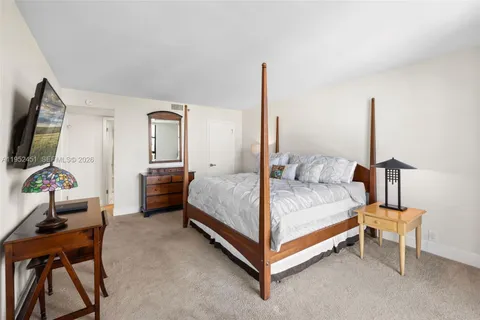 a bed room with a bed and a chair