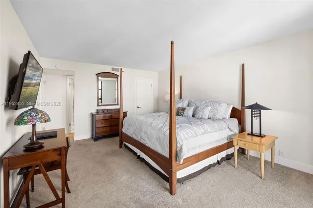 a bed room with a bed and a chair