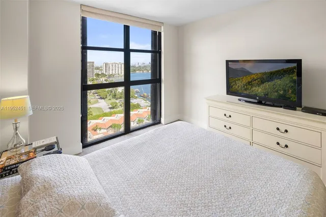 a bedroom with a bed and a flat screen tv