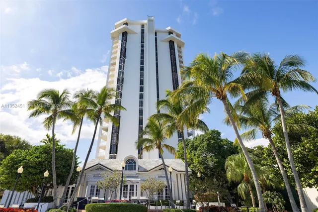 a view of a multi story building with a palm trees