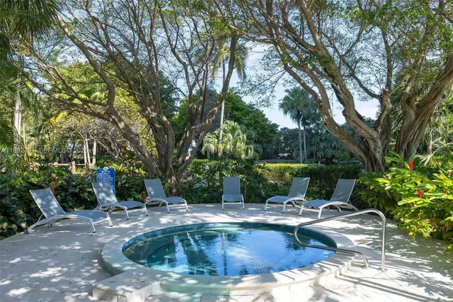 a swimming pool with outdoor seating and yard