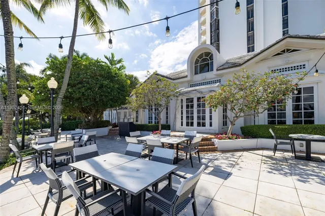 a view of a patio with table and chairs and potted plants