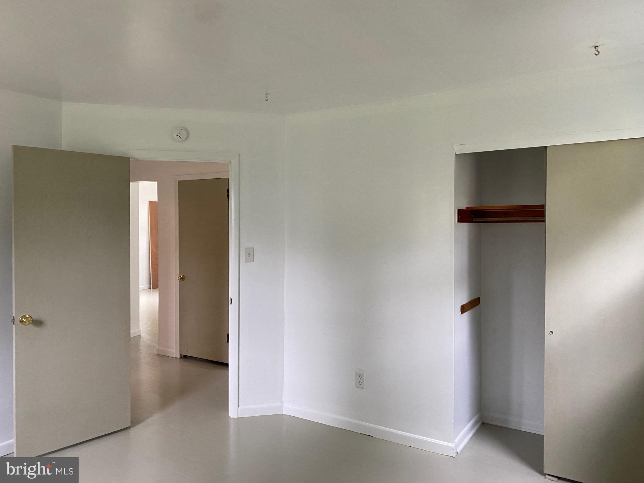 4 Riviera Drive Pennsville, NJ 08070 - Photo 12 of 22 an empty room with closet and wooden door