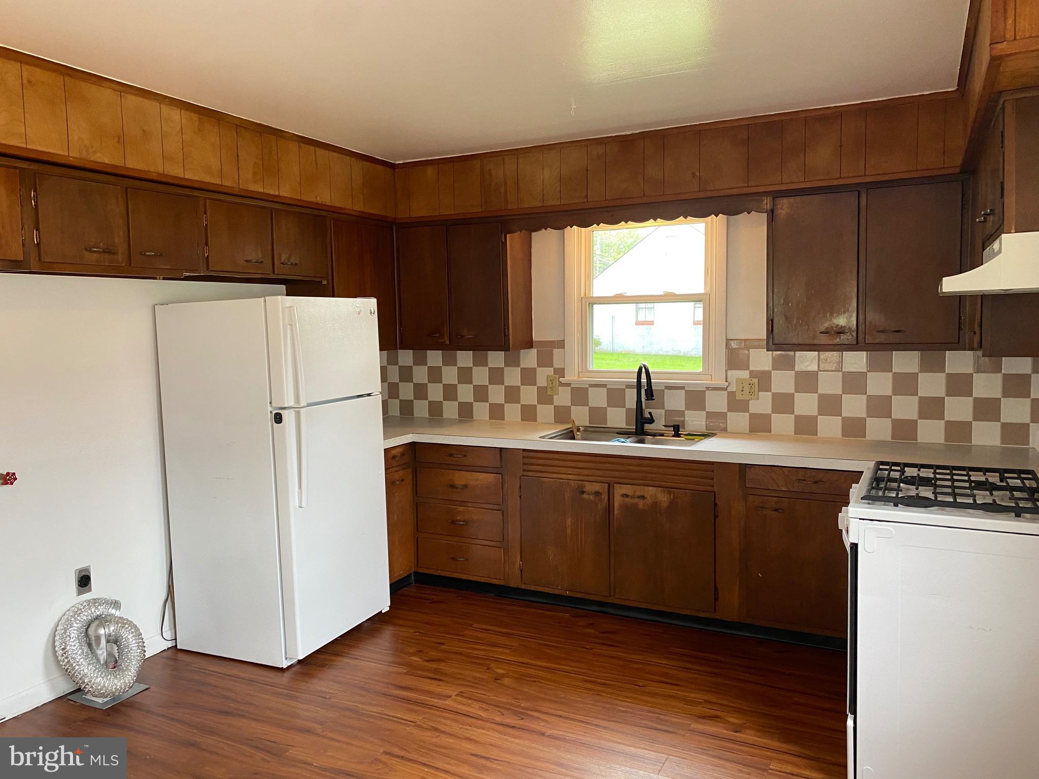 4 Riviera Drive Pennsville, NJ 08070 - Photo 4 of 22 a kitchen with granite countertop a refrigerator a sink and wooden floors