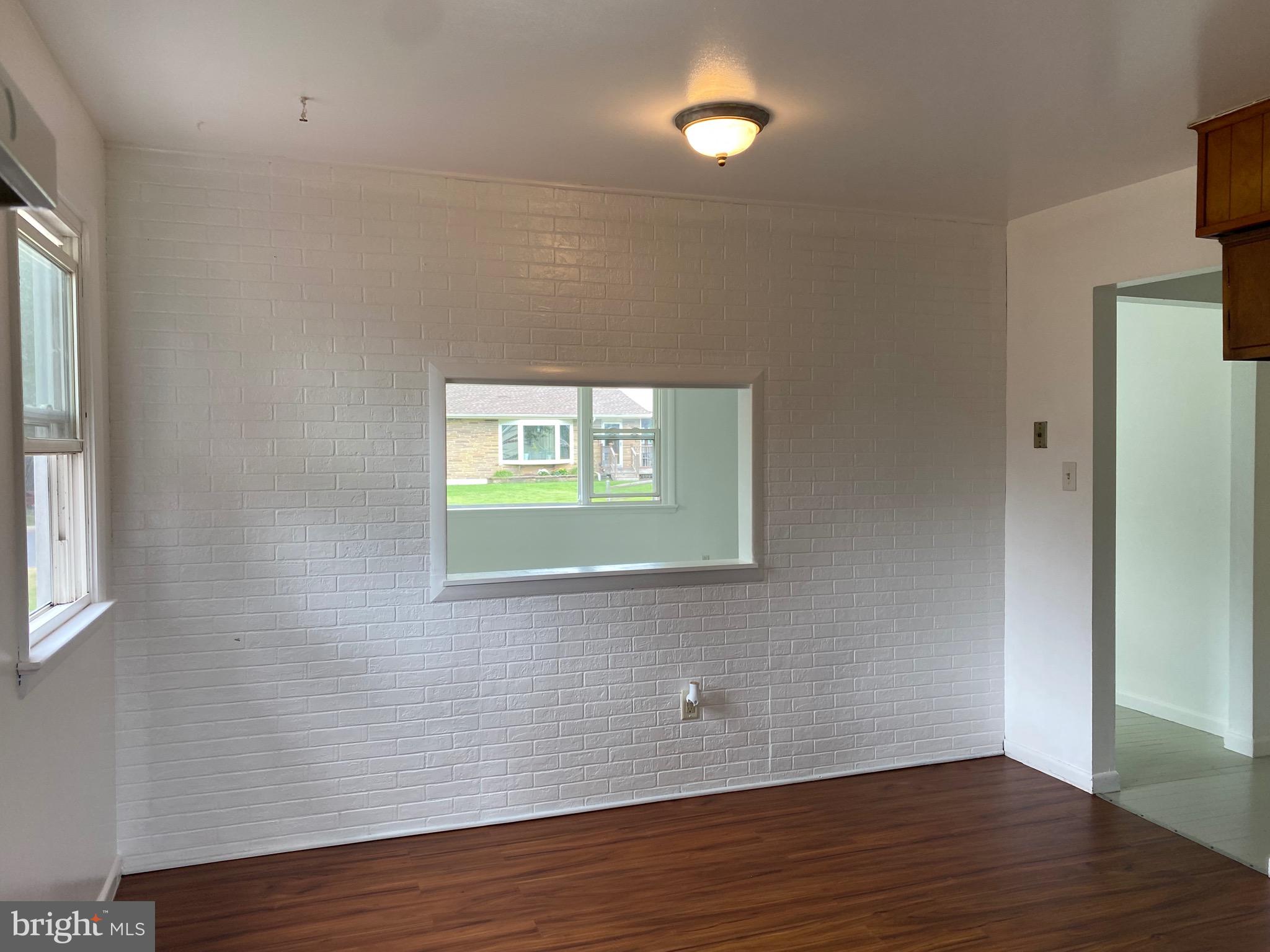 4 Riviera Drive Pennsville, NJ 08070 - Photo 6 of 22 an empty room with wooden floor and windows