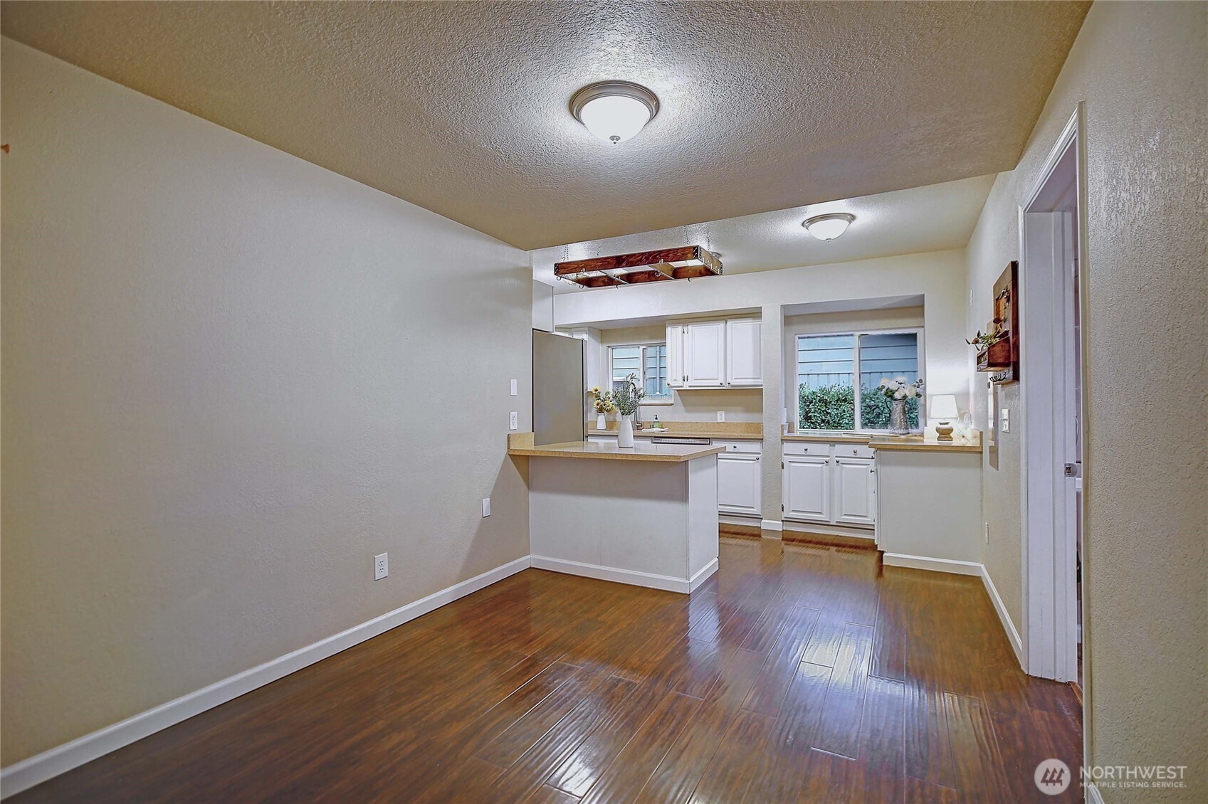 208 West Galena Street Granite Falls, WA 98252 - Photo 11 of 40 a kitchen with cabinets wooden floor and a dining table