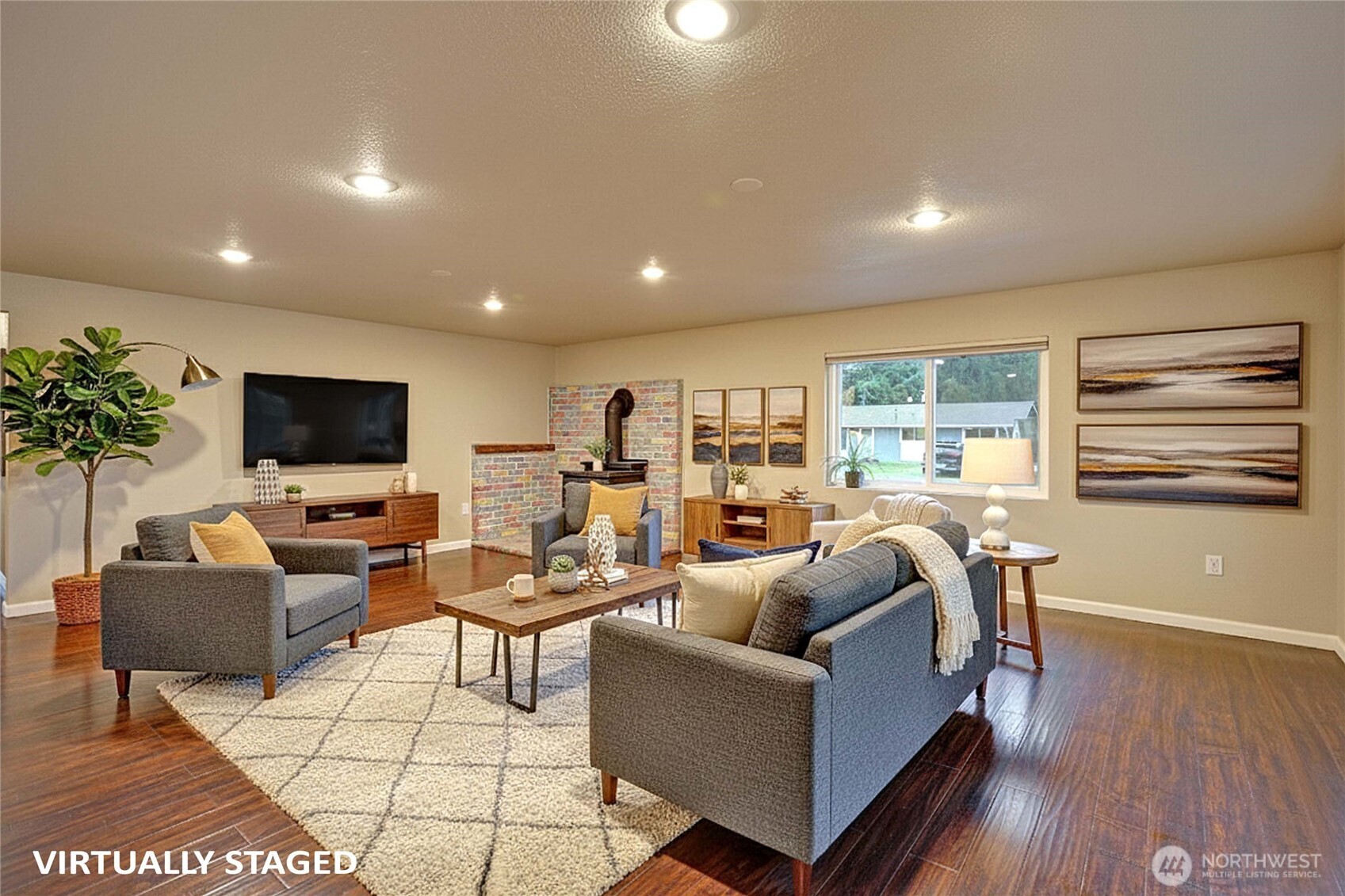 208 West Galena Street Granite Falls, WA 98252 - Photo 3 of 40 a living room with furniture a flat screen tv and a large window
