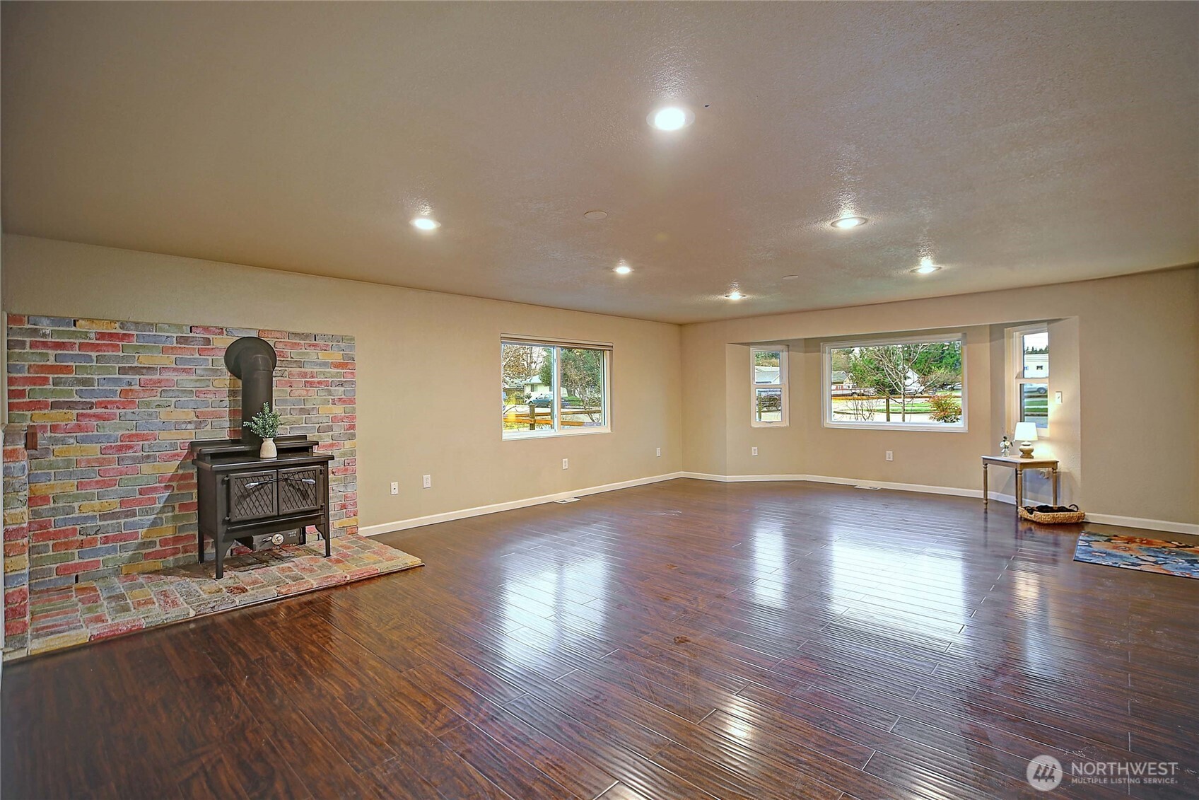 208 West Galena Street Granite Falls, WA 98252 - Photo 6 of 40 an empty room with wooden floor a kitchen view and windows