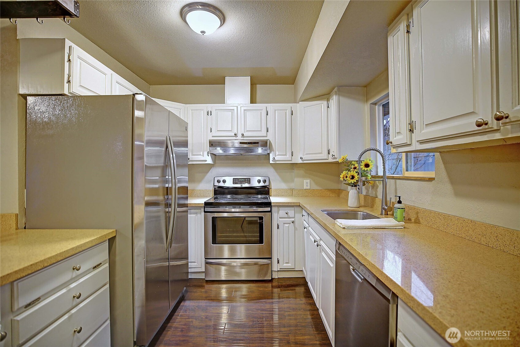 208 West Galena Street Granite Falls, WA 98252 - Photo 9 of 40 a kitchen with stainless steel appliances granite countertop a sink a stove a refrigerator and cabinets