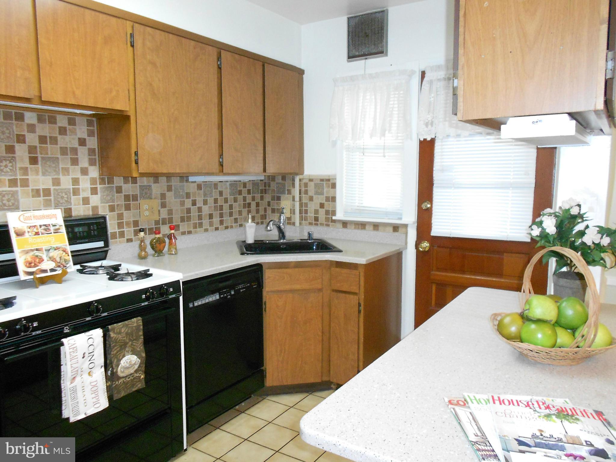 1920 Wareham Road Baltimore, MD 21222 - Photo 8 of 28 a kitchen with stainless steel appliances kitchen island granite countertop a sink a stove and a microwave