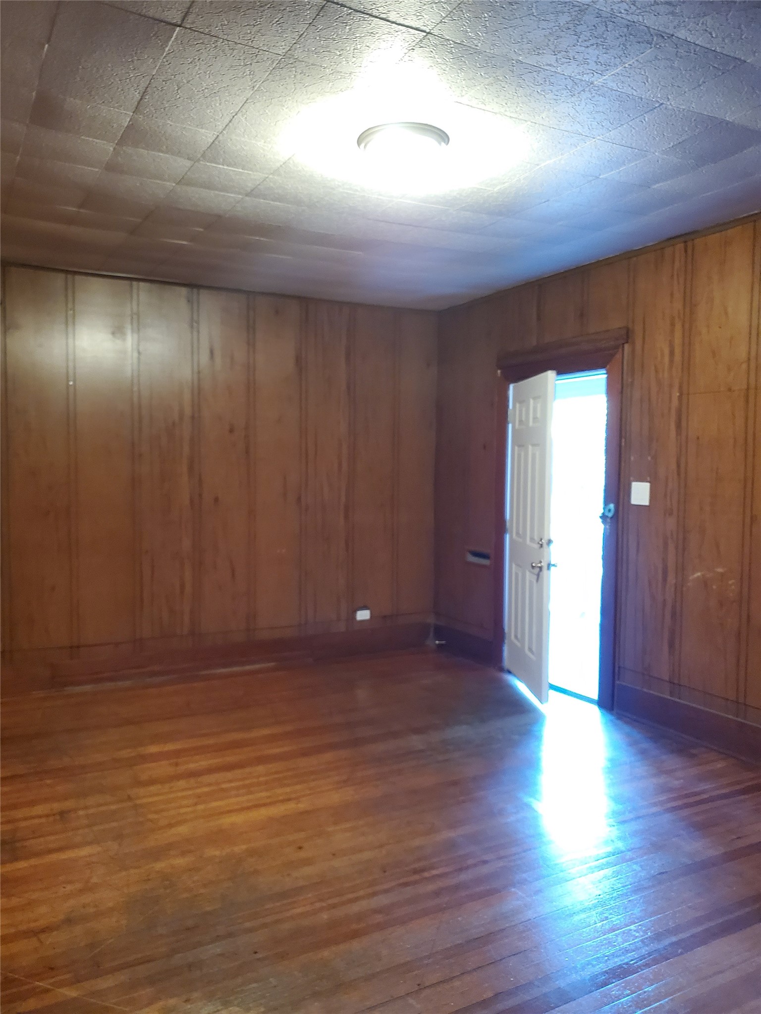 4113 Speedway Austin, TX 78751 - Photo 6 of 31 Warm wood paneling wraps this versatile room featuring classic hardwood flooring.
