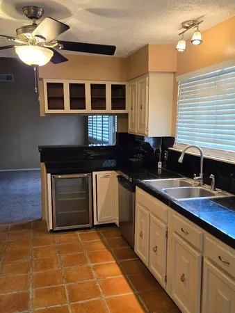 a kitchen with a sink cabinets and stove