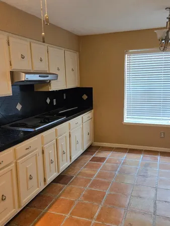 a kitchen with stainless steel appliances a sink a stove a microwave and cabinets