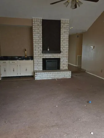 a view of a room with wooden floor and chandelier