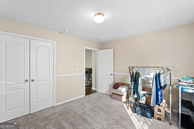 a view of a livingroom with furniture and closet