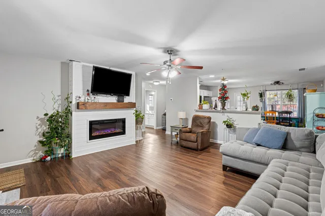 a living room with furniture a flat screen tv and a fireplace