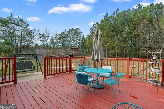 a view of a deck with furniture and wooden floor