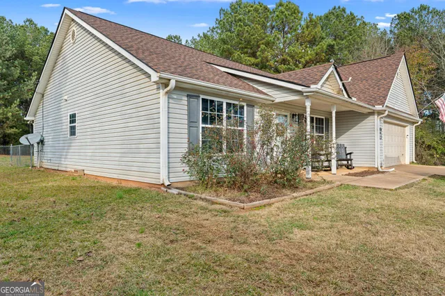 a view of a house with yard and sitting area