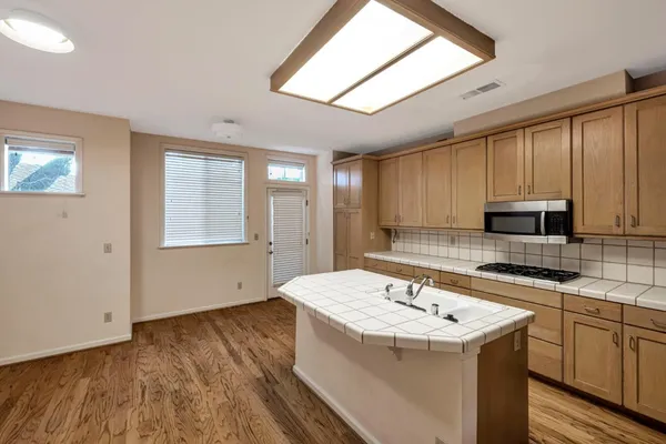 a kitchen with a sink stove and cabinets
