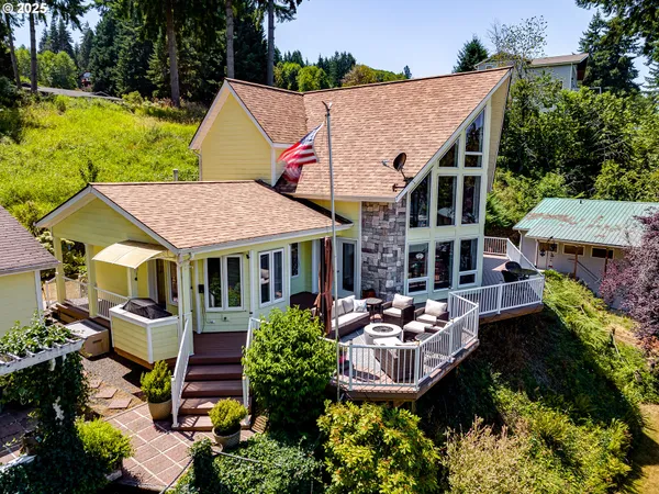 an aerial view of a house with garden space and trees