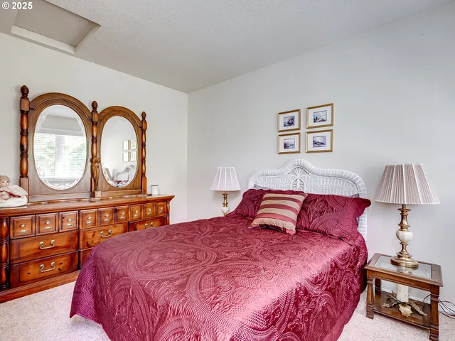 a bedroom with a bed a closet and a table