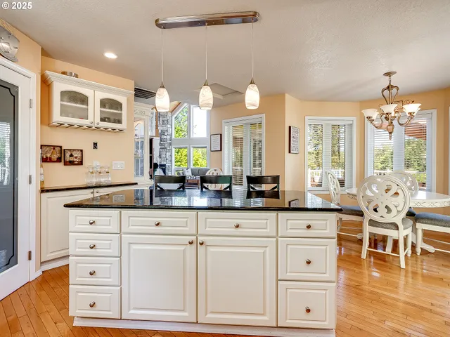 a spacious bathroom with stainless steel appliances a sink and a large mirror