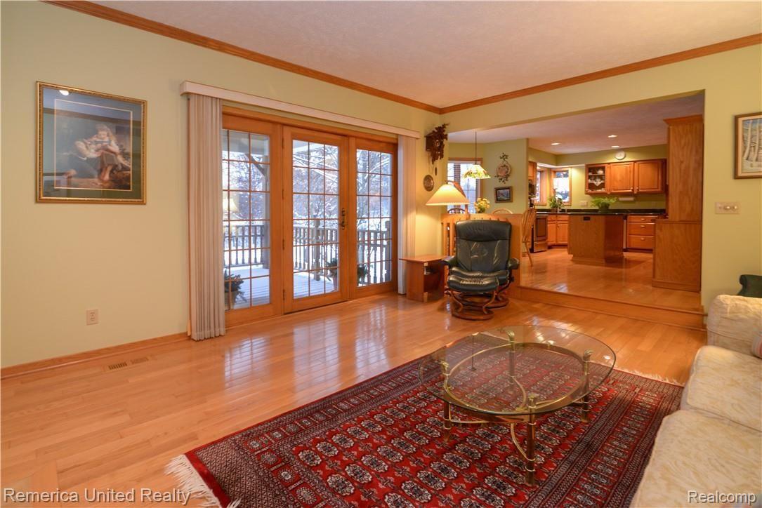 12264 Raelyn Hills Drive Perry, MI 48872 - Photo 22 of 46 Great Room w/ Door Wall to Enclosed Deck