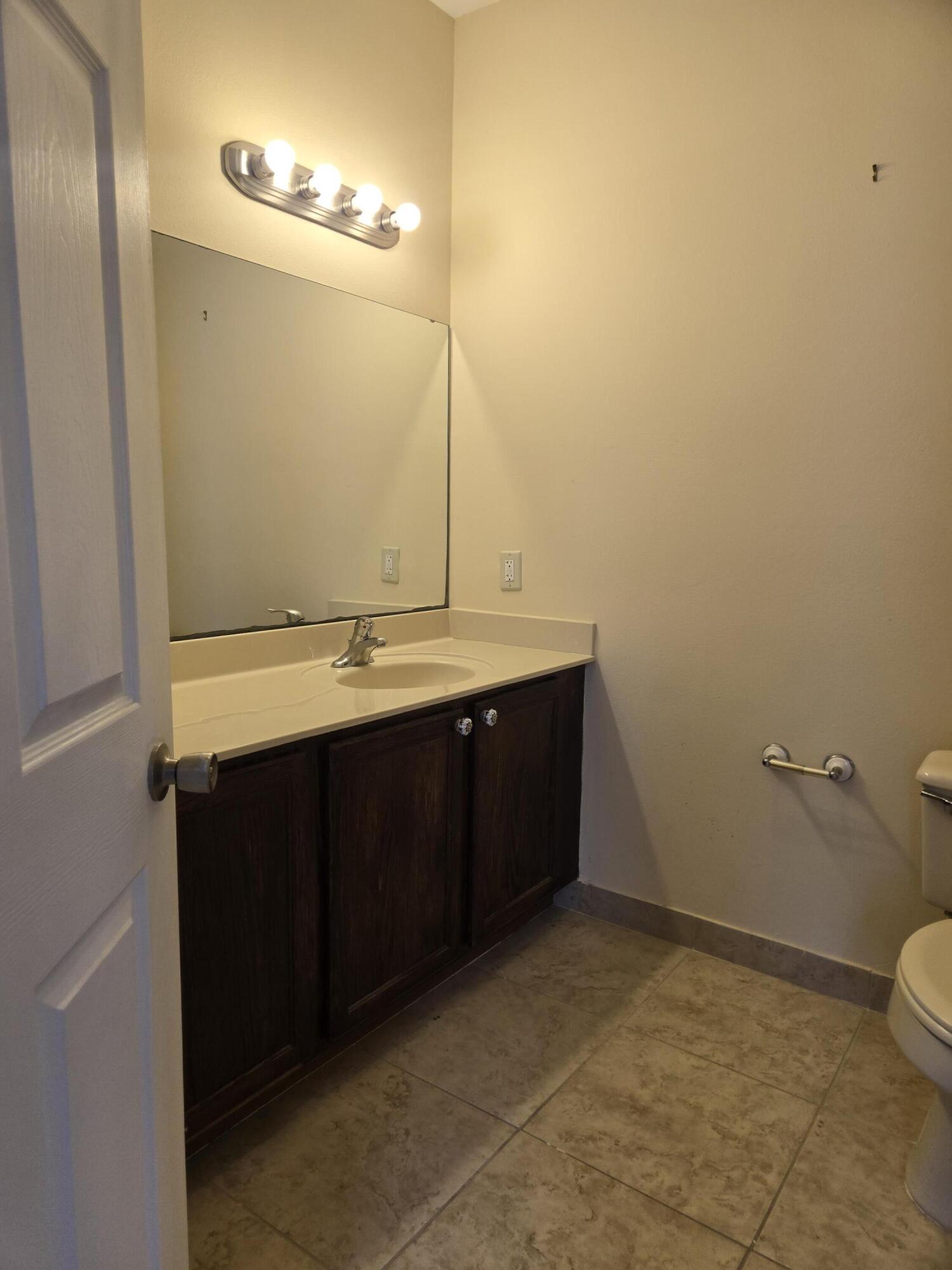 3141 Laurel Ridge Circle Riviera Beach, FL 33404 - Photo 12 of 16 a bathroom with a sink and a toilet
