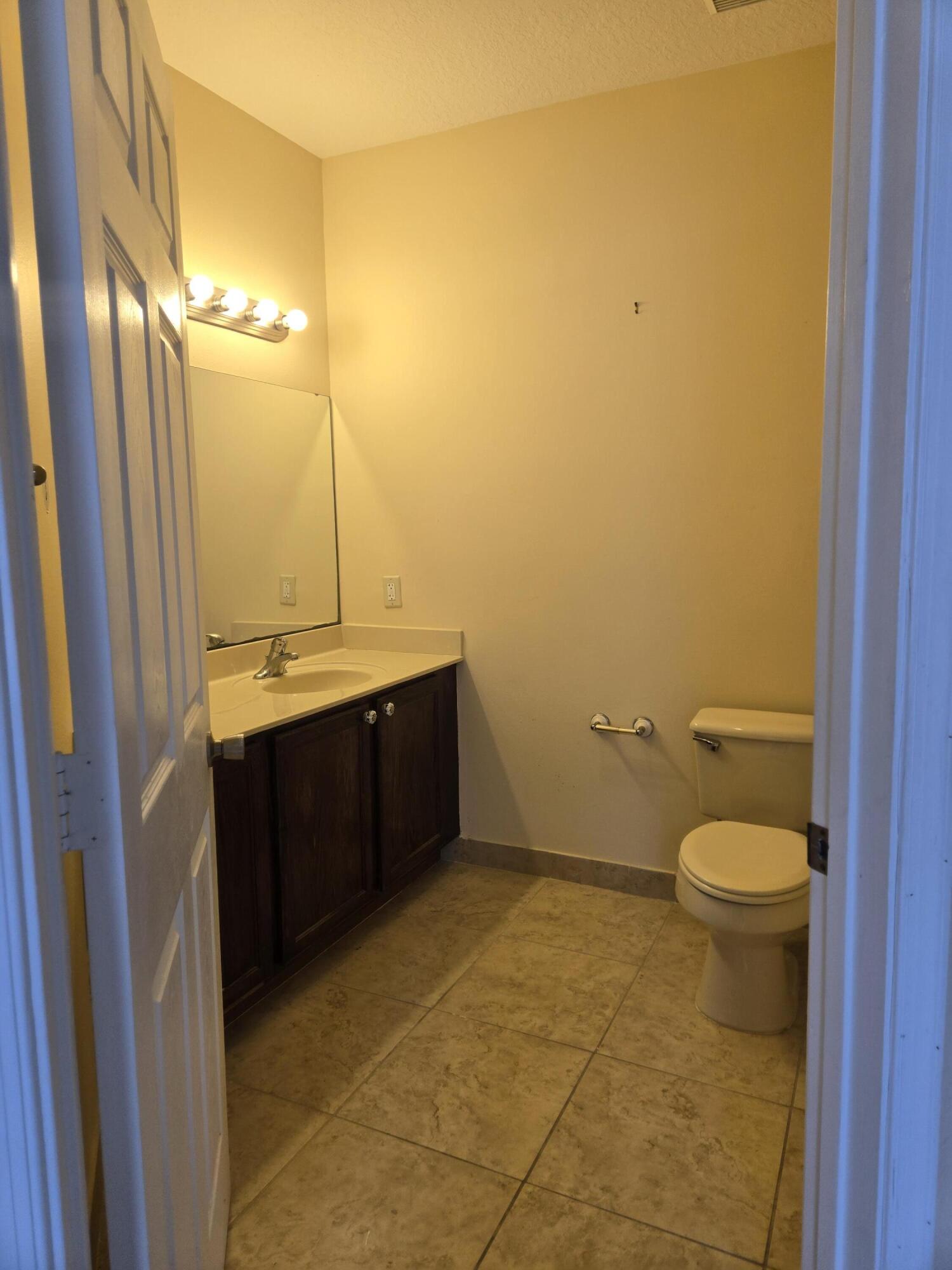 3141 Laurel Ridge Circle Riviera Beach, FL 33404 - Photo 13 of 16 a bathroom with a sink toilet and shower