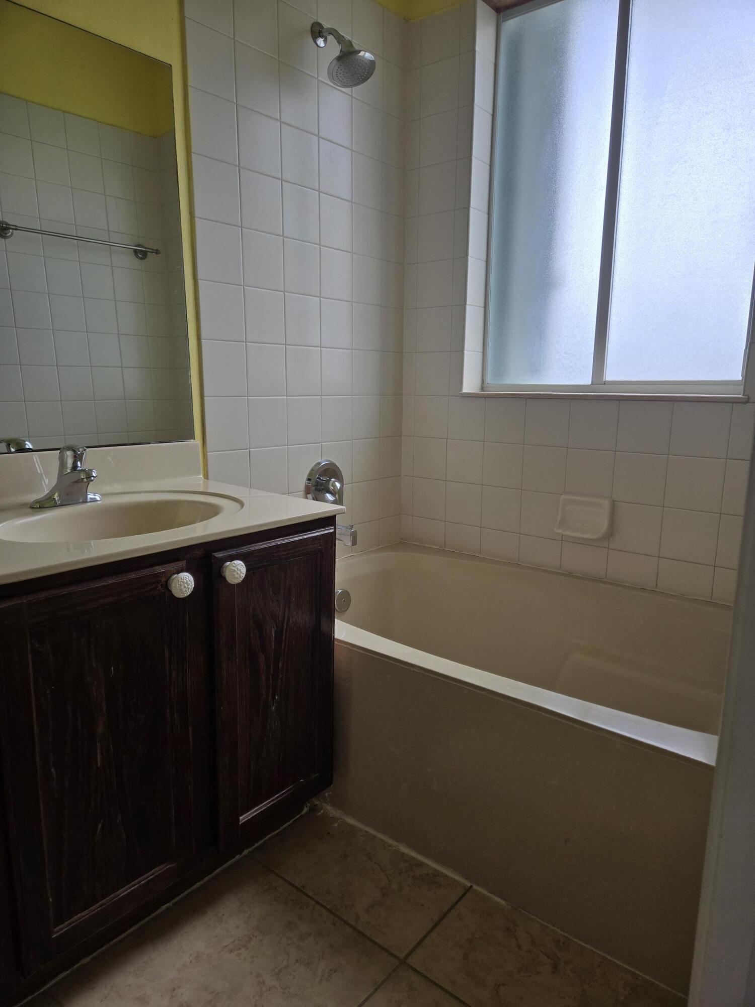 3141 Laurel Ridge Circle Riviera Beach, FL 33404 - Photo 8 of 16 a bathroom with a sink a toilet and a mirror