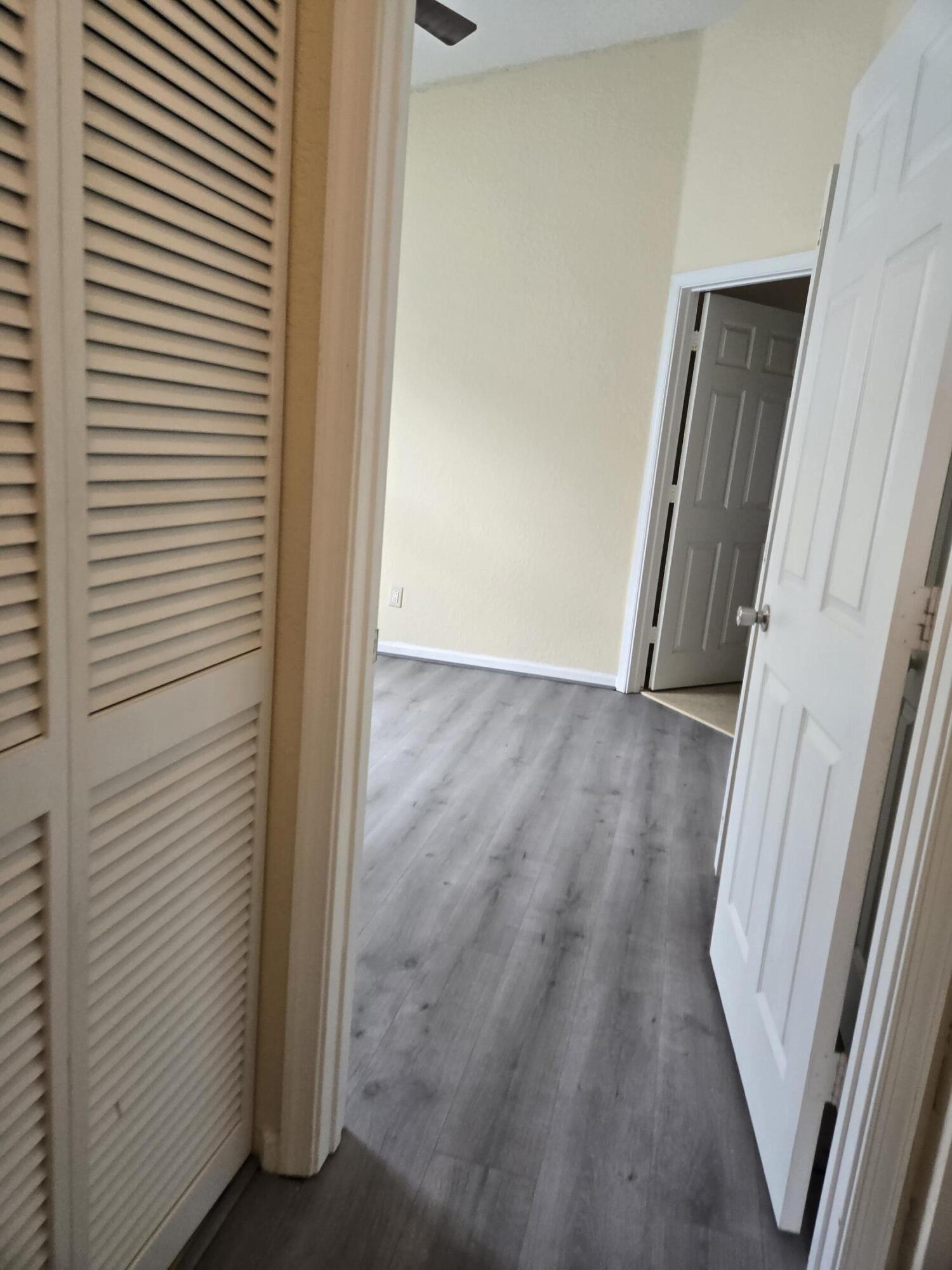 3141 Laurel Ridge Circle Riviera Beach, FL 33404 - Photo 10 of 16 a view of a hallway with wooden floor