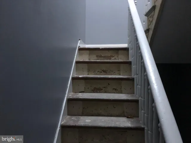 a view of a hallway with a furniture and a window