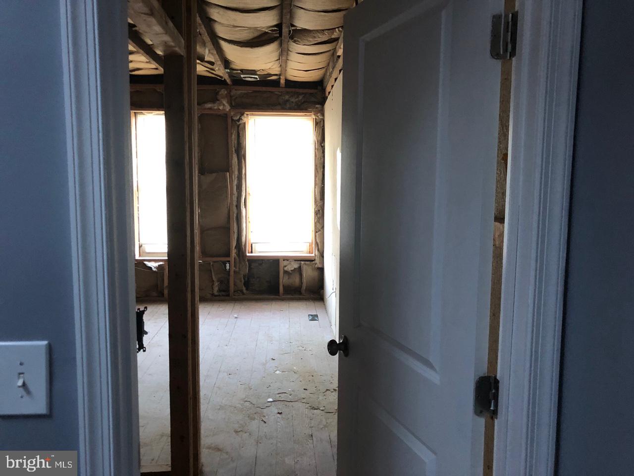 20 North Gilmor Street Baltimore, MD 21223 - Photo 13 of 19 a view of a hallway with a furniture and a window