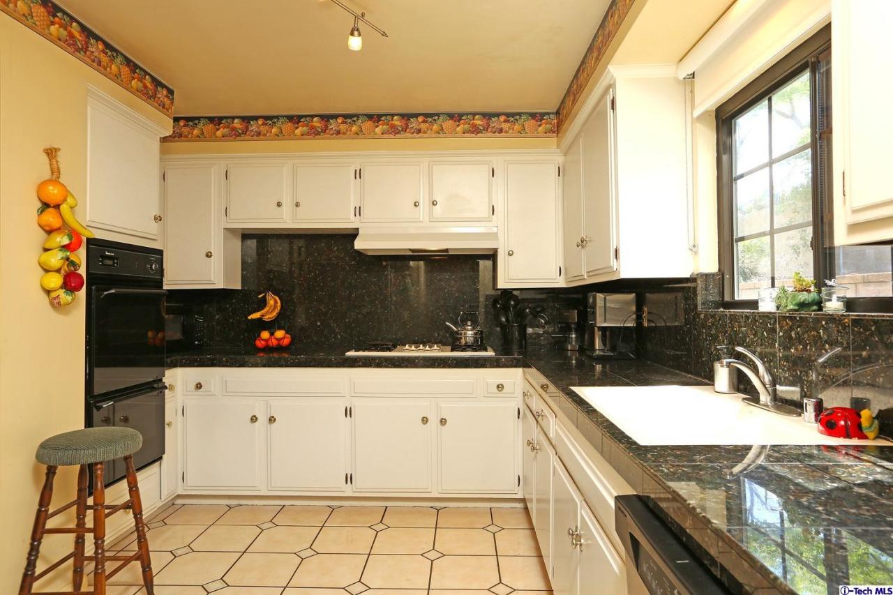 1023 North Old Ranch Road Arcadia, CA 91006 - Photo 14 of 32 a kitchen with granite countertop a stove a sink and a refrigerator