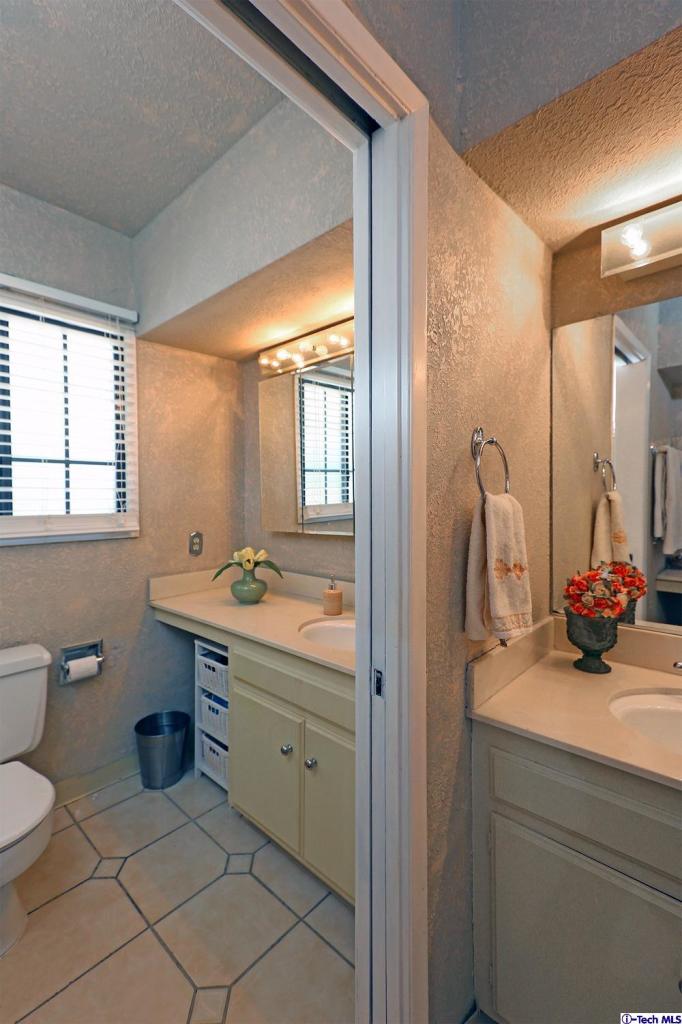 1023 North Old Ranch Road Arcadia, CA 91006 - Photo 24 of 32 a bathroom with a double vanity sink toilet mirror and window