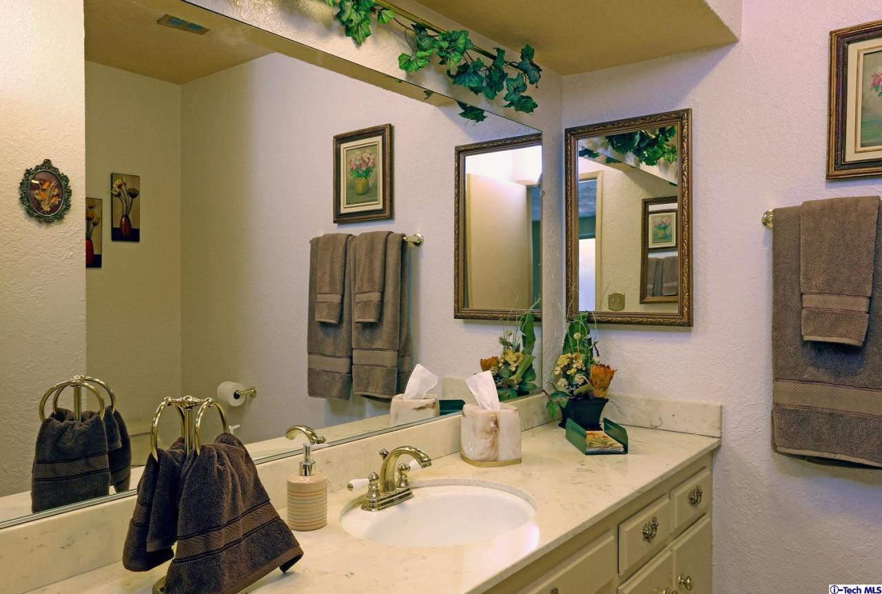1023 North Old Ranch Road Arcadia, CA 91006 - Photo 26 of 32 a bathroom with a granite countertop sink and a mirror