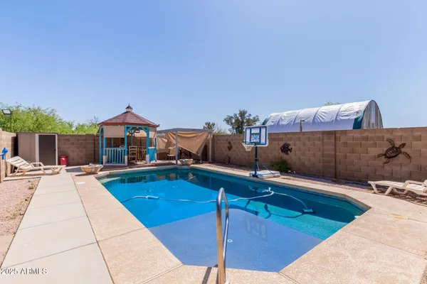 a swimming pool with some trees in the background