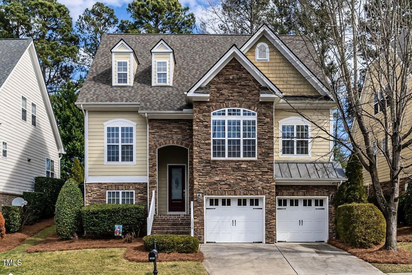 1028 Dotson Way Apex, NC 27523 - Photo 1 of 52 a front view of a house with garage