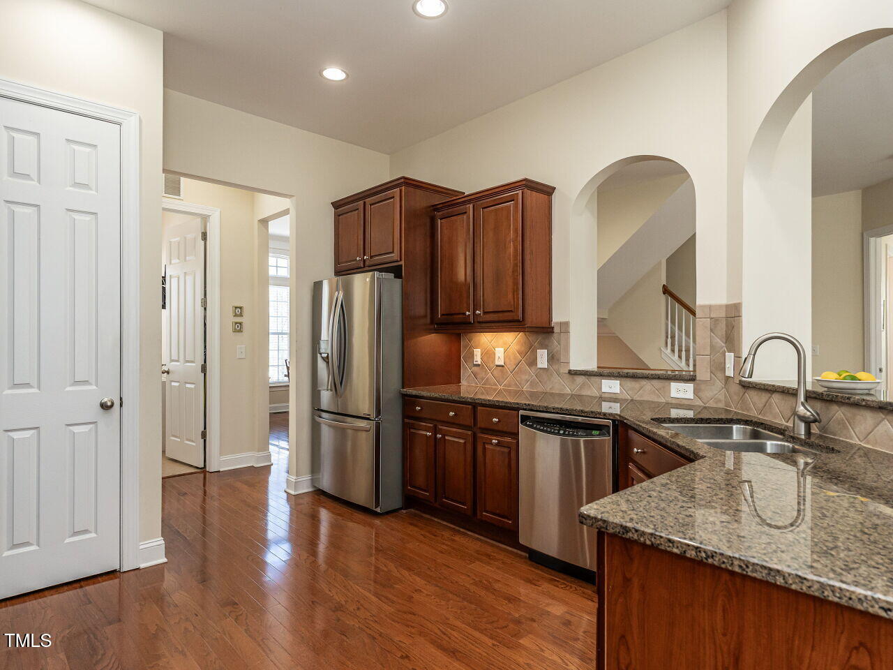 1028 Dotson Way Apex, NC 27523 - Photo 12 of 52 a kitchen with stainless steel appliances granite countertop a sink stove and refrigerator