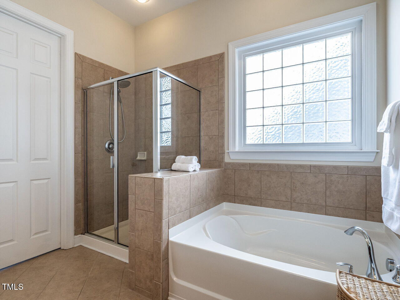 1028 Dotson Way Apex, NC 27523 - Photo 19 of 52 a bathroom with a bathtub and shower