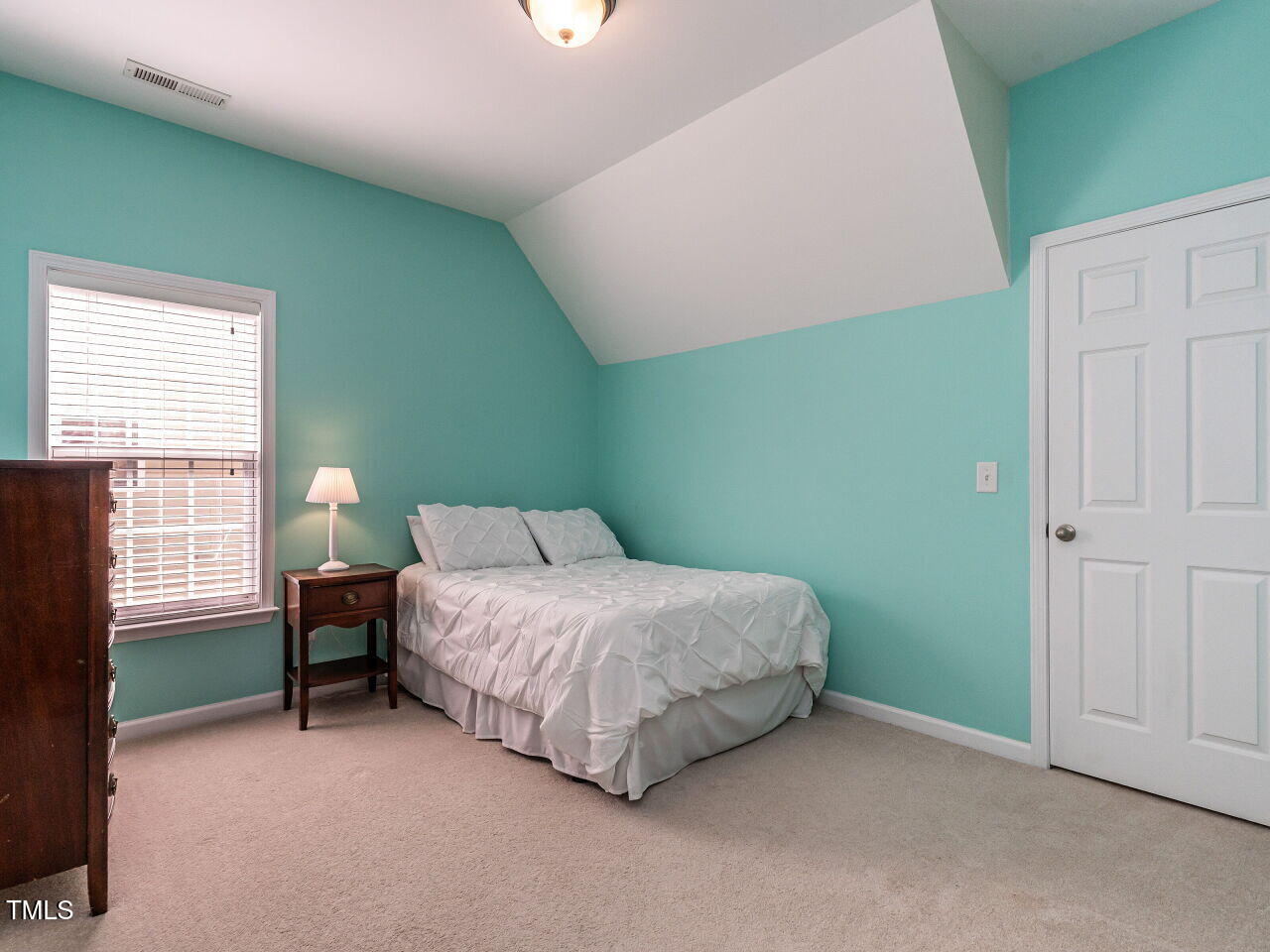 1028 Dotson Way Apex, NC 27523 - Photo 20 of 52 a spacious bedroom with a bed and a window