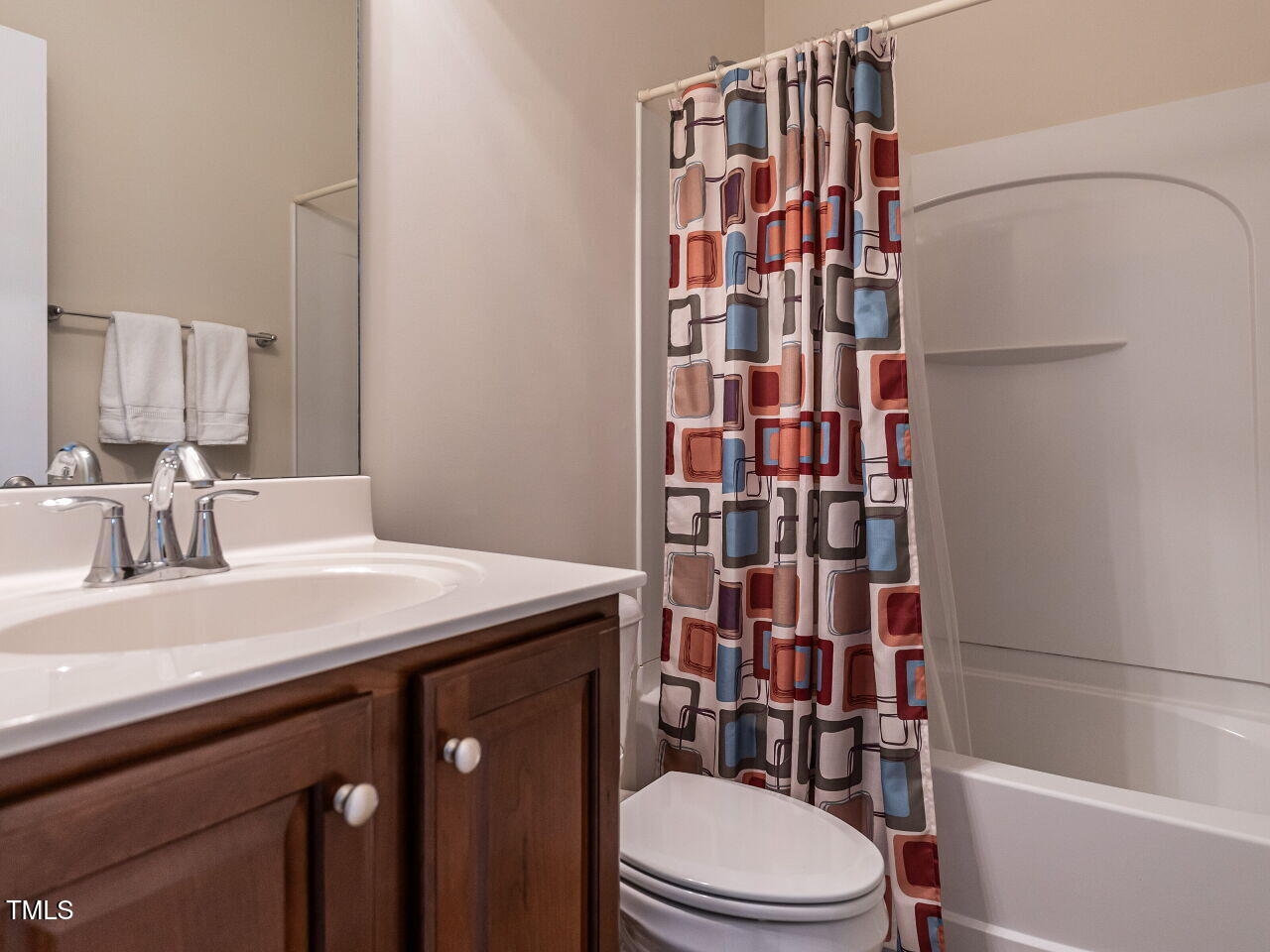 1028 Dotson Way Apex, NC 27523 - Photo 25 of 52 a bathroom with a sink a toilet and shower