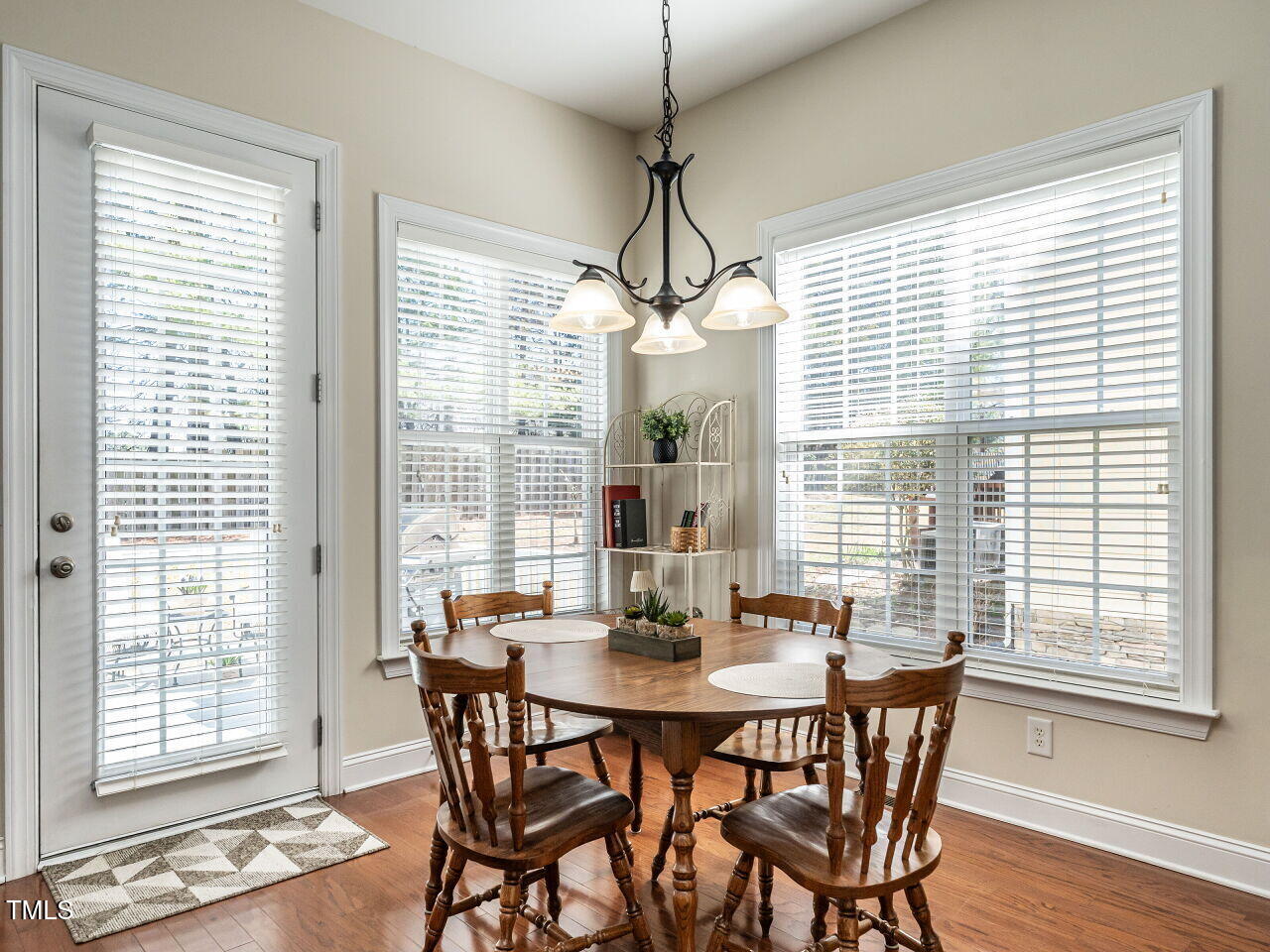 1028 Dotson Way Apex, NC 27523 - Photo 9 of 52 a view of a dining room with furniture wooden floor and chandelier