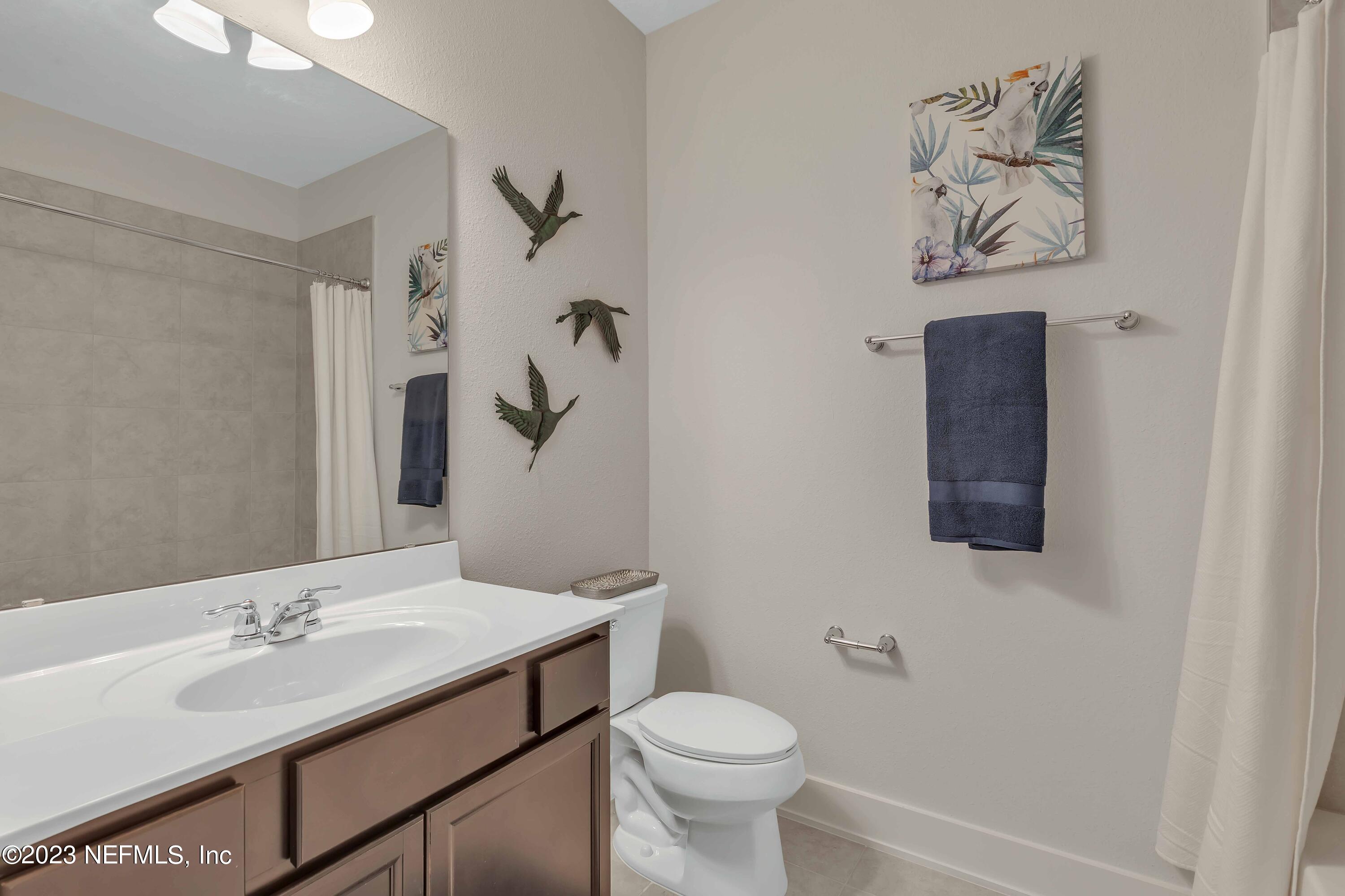 417 Cherry Elm Drive, Unit 73 St. Augustine, FL 32092 - Photo 15 of 29 a bathroom with a sink vanity mirror and toilet