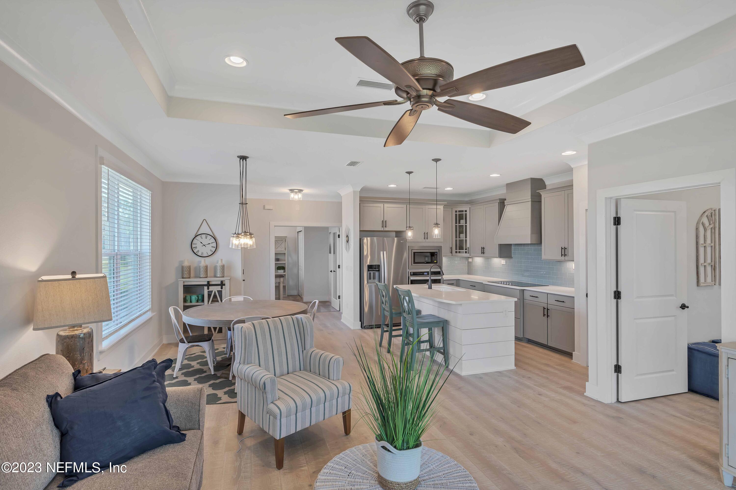 417 Cherry Elm Drive, Unit 73 St. Augustine, FL 32092 - Photo 8 of 29 a living room with kitchen island furniture and a chandelier