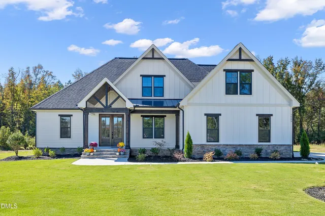 a front view of house with yard and green space