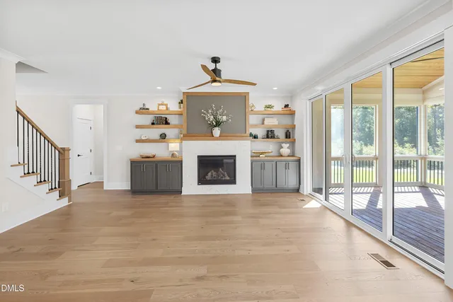 a view of a hallway with an entryway and fireplace