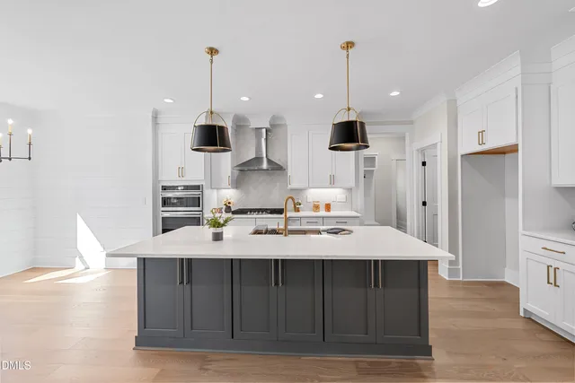 a large kitchen with kitchen island a island in the center