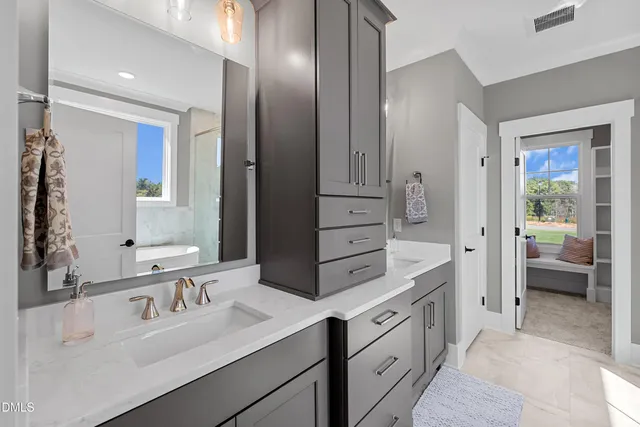 a white bath tub sitting next to a shower