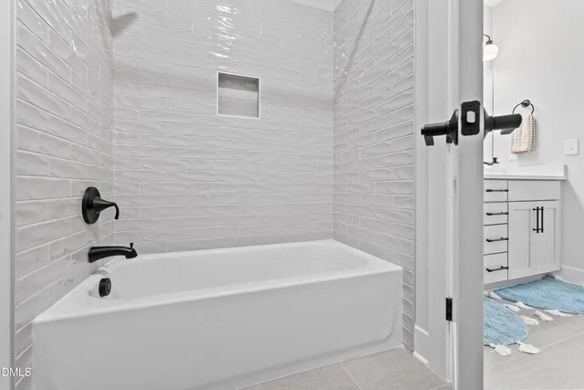 a bathroom with double vanity sinks a vanity a lamp and a mirror